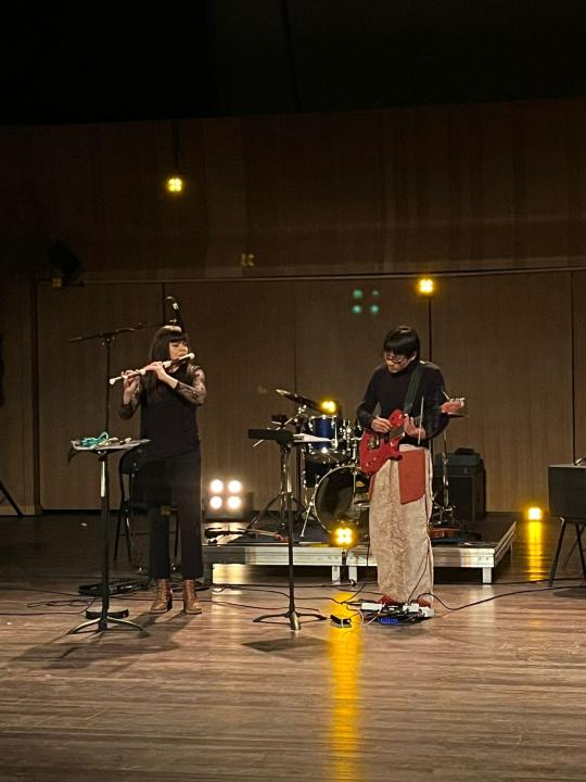 A Portrait of Violeta and Sikai, performing in the Jack Ralite Auditorium in Paris
