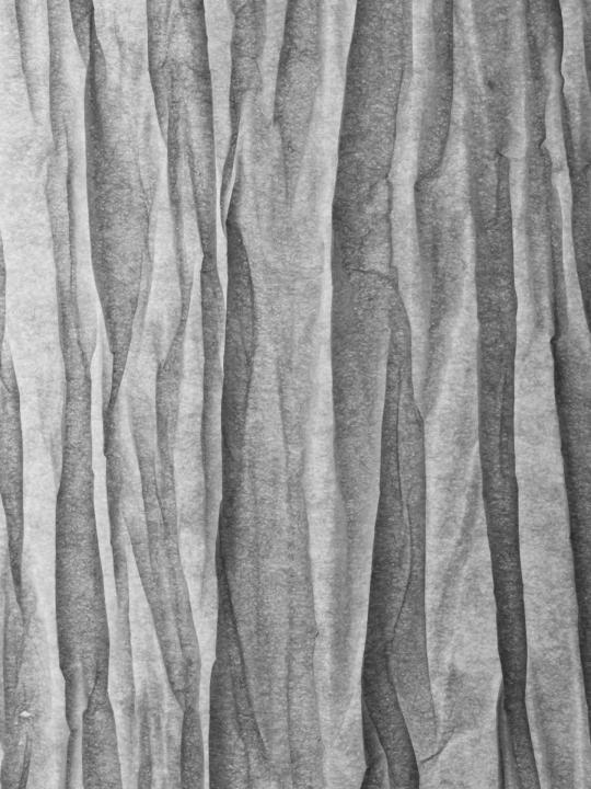 Artwork showing a folded sheet of paper evoking the album Interfolding Pieces: black and white